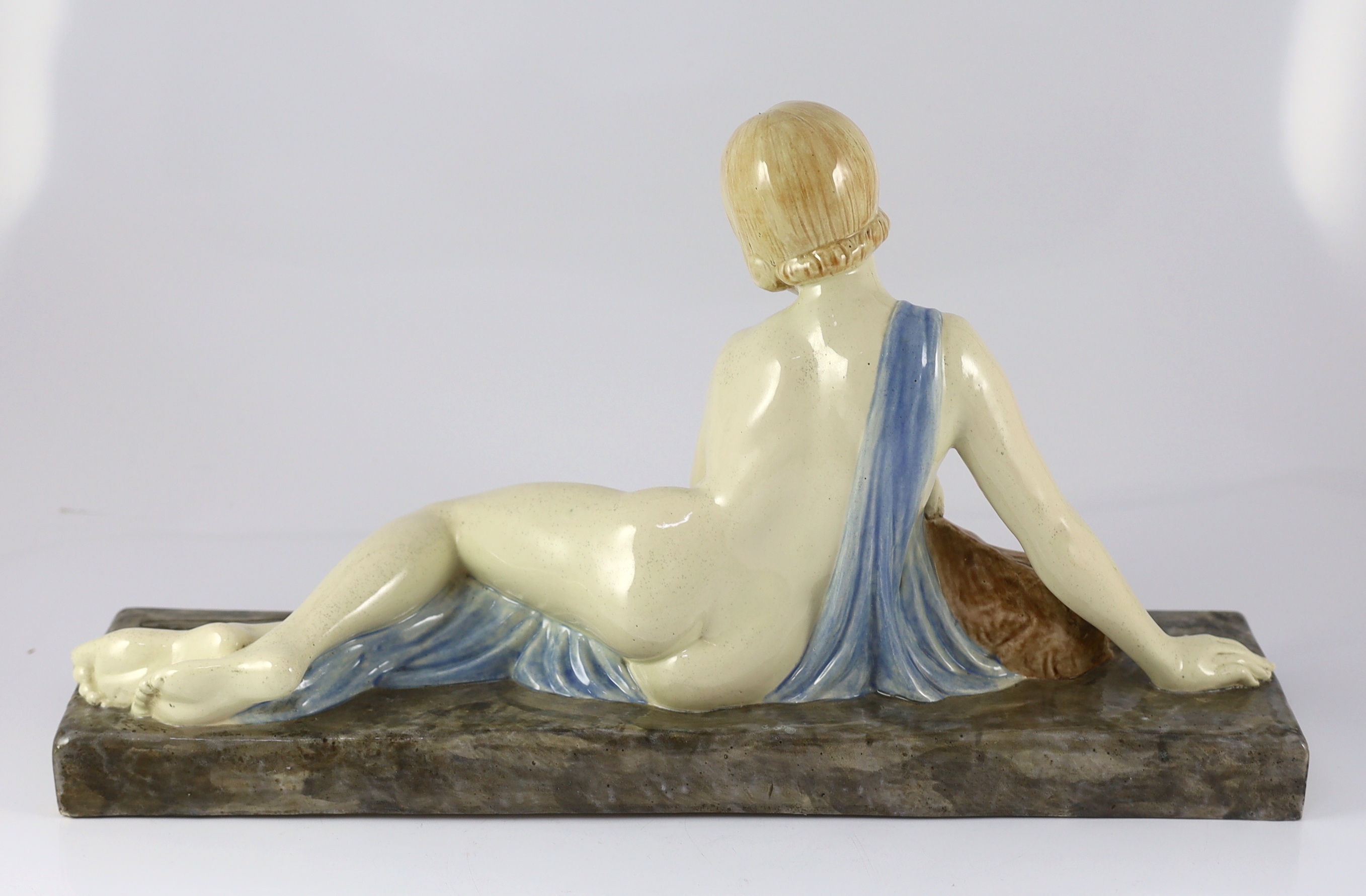 Armand Godard (French, 1824-1887). An Art Deco ceramic group of a reclining beauty with a kid